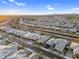 Wide aerial shot capturing a vast neighborhood with uniform housing designs and desert landscaping under a clear sky at 22884 E Via De Olivos --, Queen Creek, AZ 85142