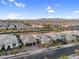 Expansive aerial view of a meticulously planned community showcasing modern homes and scenic mountain views at 22884 E Via De Olivos --, Queen Creek, AZ 85142