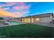 Expansive backyard with a private pool, lush green lawn, covered patio, and desert landscaping at 22884 E Via De Olivos --, Queen Creek, AZ 85142