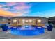Stunning backyard showcasing a private pool, lush landscaping, and a spacious covered patio at 22884 E Via De Olivos --, Queen Creek, AZ 85142