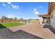 Expansive backyard featuring a pool with water feature, gravel landscaping and grass lawn at 22884 E Via De Olivos --, Queen Creek, AZ 85142