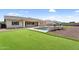 Beautiful backyard showcasing a pristine pool, putting green, and lush artificial turf, ideal for outdoor recreation at 22884 E Via De Olivos --, Queen Creek, AZ 85142