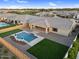 Inviting backyard with a custom-designed pool, lush green lawn, and ample space for outdoor activities and relaxation at 22884 E Via De Olivos --, Queen Creek, AZ 85142