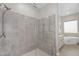 Bathroom featuring a shower, glass door, seating and tile surround at 22884 E Via De Olivos --, Queen Creek, AZ 85142