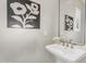 Chic powder room featuring a stylish pedestal sink, brushed nickel faucet, decorative mirror, and modern artistic wall art at 22884 E Via De Olivos --, Queen Creek, AZ 85142