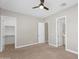 Bedroom featuring neutral paint, carpet, a ceiling fan, and multiple doorways at 22884 E Via De Olivos --, Queen Creek, AZ 85142