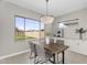 Bright dining area featuring hardwood table and chairs with backyard views showcasing a putting green at 22884 E Via De Olivos --, Queen Creek, AZ 85142
