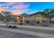 Inviting home with manicured landscaping, desert shrubs, a brick driveway, and a spacious three-car garage at 22884 E Via De Olivos --, Queen Creek, AZ 85142