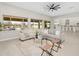 A brightly lit living room featuring neutral paint, hardwood floor, modern sofas, and backyard pool views at 22884 E Via De Olivos --, Queen Creek, AZ 85142