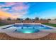 Sparkling backyard pool with manicured turf, framed by lush landscaping and a clear, expansive sky at 22884 E Via De Olivos --, Queen Creek, AZ 85142