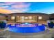 Inviting backyard pool with blue tile and stone surround offers the perfect place to relax and enjoy outdoor living at 22884 E Via De Olivos --, Queen Creek, AZ 85142