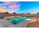 Backyard pool at twilight boasts well-designed steps and desert landscaping, creating an inviting outdoor retreat at 22884 E Via De Olivos --, Queen Creek, AZ 85142