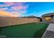 Backyard putting green features green turf, enclosed by a brick perimeter, creating a tranquil outdoor space at 22884 E Via De Olivos --, Queen Creek, AZ 85142