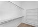 Spacious walk-in closet with shelving, providing ample storage space in neutral color palette at 22884 E Via De Olivos --, Queen Creek, AZ 85142