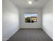 Bright bedroom featuring neutral carpet and a large window overlooking lush landscaping and neighboring homes at 2367 E Rosario Mission Dr, Casa Grande, AZ 85194