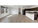 Bright, open-concept living room and kitchen with modern finishes and wood-look flooring at 2367 E Rosario Mission Dr, Casa Grande, AZ 85194