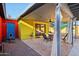 Cozy backyard with a covered patio and seating area, featuring colorful exterior walls at 2511 E Pinchot Ave, Phoenix, AZ 85016