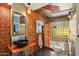 Unique bathroom featuring exposed brick, a vessel sink, modern fixtures, and glass block shower at 2511 E Pinchot Ave, Phoenix, AZ 85016