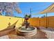 Charming backyard fountain surrounded by brickwork and yellow walls, creating a serene atmosphere at 2511 E Pinchot Ave, Phoenix, AZ 85016