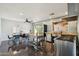 Spacious kitchen with stainless steel appliances, a kitchen island, and a dining area with modern chairs at 2511 E Pinchot Ave, Phoenix, AZ 85016