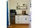 Efficient kitchenette with white cabinets, a stainless steel refrigerator, and open shelving at 2511 E Pinchot Ave, Phoenix, AZ 85016