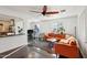 Open concept home showcasing an orange sectional sofa, grand piano, and view into the kitchen at 2511 E Pinchot Ave, Phoenix, AZ 85016