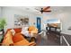 Modern living room featuring a stylish orange sectional couch, dark floors and white walls for a clean, bright space at 2511 E Pinchot Ave, Phoenix, AZ 85016
