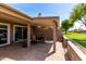Serene backyard featuring a covered patio and well-maintained landscaping at 25238 S Mohawk Dr, Sun Lakes, AZ 85248