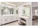 Spacious bathroom featuring dual sinks, a vanity area, and stylish mirrors at 25238 S Mohawk Dr, Sun Lakes, AZ 85248