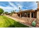 Charming single-story home featuring a covered patio and well-manicured lawn, perfect for outdoor living at 25238 S Mohawk Dr, Sun Lakes, AZ 85248