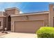 A front view of a well kept home with a desert landscape and a large two car garage at 25238 S Mohawk Dr, Sun Lakes, AZ 85248