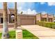 A front view of a well kept home with a desert landscape and a large two car garage at 25238 S Mohawk Dr, Sun Lakes, AZ 85248
