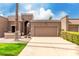 Charming home with a gated entry, brown garage door, desert landscaping, and a beautiful blue sky at 25238 S Mohawk Dr, Sun Lakes, AZ 85248