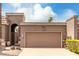 Close up of a large two car brown garage door with address numbers and desert landscaping at 25238 S Mohawk Dr, Sun Lakes, AZ 85248