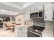 Modern kitchen with stainless steel appliances, white cabinets, and stone backsplash at 25238 S Mohawk Dr, Sun Lakes, AZ 85248