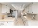 Bright kitchen featuring white cabinetry, neutral countertops, tile backsplash, and modern appliances at 25238 S Mohawk Dr, Sun Lakes, AZ 85248