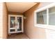 Inviting outdoor patio with a window and glass doors leading into the home's interior at 25238 S Mohawk Dr, Sun Lakes, AZ 85248