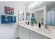 Bright bathroom with double sinks, marble countertops, and decorative towels at 255 S Kyrene Rd # 212, Chandler, AZ 85226