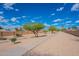 Scenic community path with desert landscaping, mature trees, and clear blue skies, perfect for walking or biking at 255 S Kyrene Rd # 212, Chandler, AZ 85226