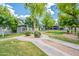 Well-maintained community grounds with mature trees, lush landscaping, and walkways at 255 S Kyrene Rd # 212, Chandler, AZ 85226
