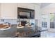 Modern kitchen features granite countertops and stainless steel appliances, with an adjacent view of the living room at 255 S Kyrene Rd # 212, Chandler, AZ 85226