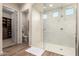 Bathroom with glass shower, walk-in closet, and toilet; clean modern style with white and wood accents at 26999 W Ponderosa Ln, Buckeye, AZ 85396