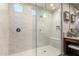Modern bathroom featuring a glass-enclosed shower with dual showerheads and elegant marble-style tile at 26999 W Ponderosa Ln, Buckeye, AZ 85396