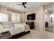 Comfortable bedroom features TV, plush carpet and curtains, providing a tranquil retreat at 26999 W Ponderosa Ln, Buckeye, AZ 85396