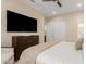 Bedroom featuring a large TV, a view to the hallway, and comfortable, light-toned bedding at 26999 W Ponderosa Ln, Buckeye, AZ 85396
