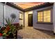 Enclosed courtyard with patterned brick, a bench, and a decorative metal sunburst wall hanging at 26999 W Ponderosa Ln, Buckeye, AZ 85396
