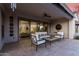 Inviting covered patio with comfortable seating, ceiling fan, and access to indoor living space at 26999 W Ponderosa Ln, Buckeye, AZ 85396