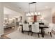 Open dining area with a chandelier, next to the living room and kitchen at 26999 W Ponderosa Ln, Buckeye, AZ 85396