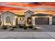 Charming single-story home with landscaped front yard and desert landscaping under a colorful dusk sky at 26999 W Ponderosa Ln, Buckeye, AZ 85396