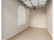 Clean and tidy garage space with epoxy flooring, window, and a garage door opener at 26999 W Ponderosa Ln, Buckeye, AZ 85396